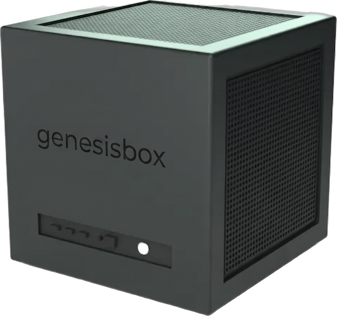 GenesisBox: a compact dark-green metal cube computer with a ventilated mesh top, a perforated side grille and the genesisbox wordmark on the front